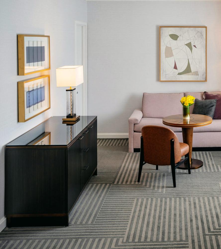 Modern hotel casegoods with black dresser and custom table at Capital Hilton hotel