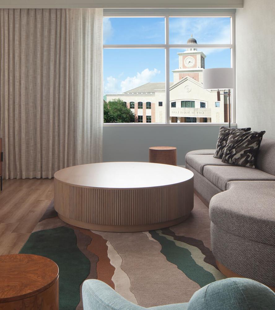 Inviting hotel lounge with round coffee table and city view at Marriott Sugarland hotel