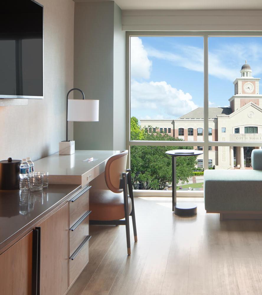 Streamlined hotel workspace with built-in storage and sleek modern finishes at Marriott Sugarland hotel