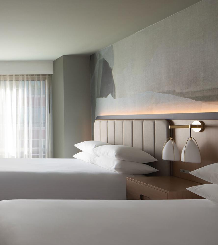 Elegant hotel bedroom with upholstered headboard and soft lighting at Marriott Sugarland hotel
