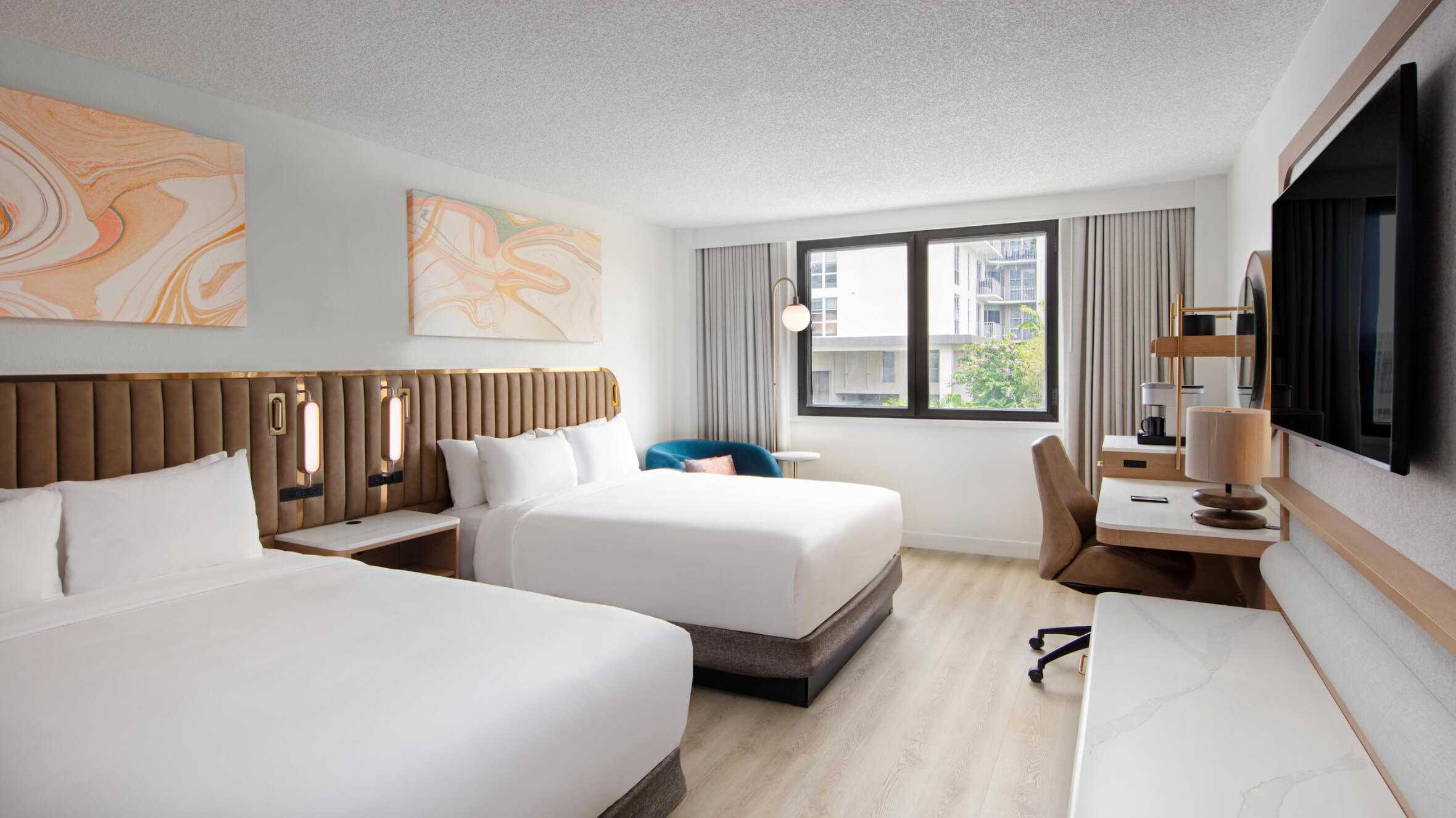 View in to double queen bed guestroom with hospitality furniture at the Sonesta Miami