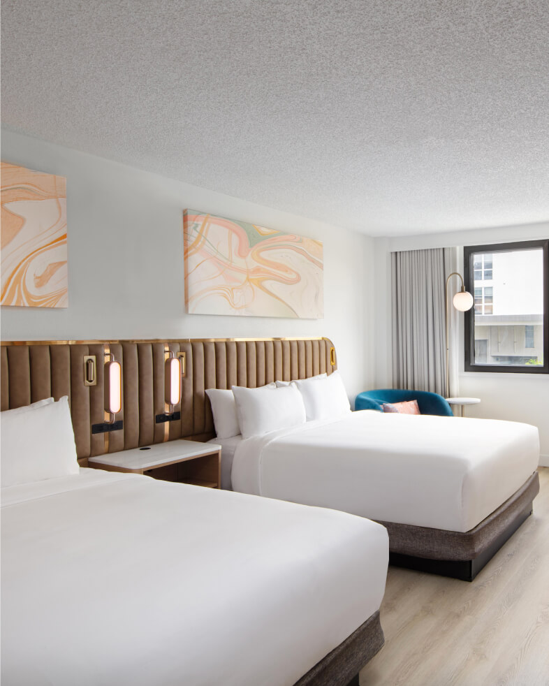 View in to double queen bed guestroom with hospitality furniture at the Sonesta Miami
