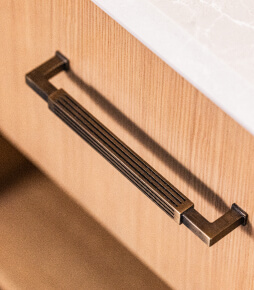 A close up shot of a drawer showing a brass drawer handle