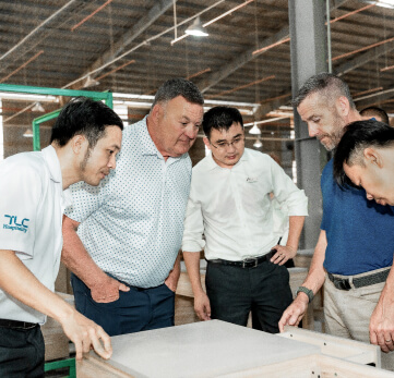 The TLC Hospitality team inspecting case goods in Vietnam.