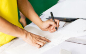A worker inspecting furniture drawings