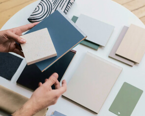 A member of the TLC hospitality team selecting furniture material finishes