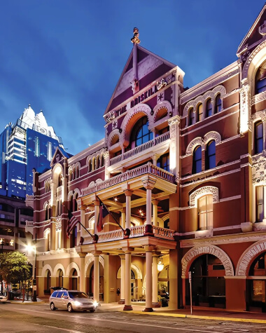 An old hotel facade up-lit with warm lights