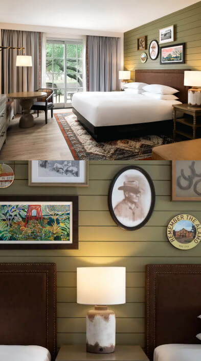 A hotel room showing bed, sofa and side tables with trees outside the window