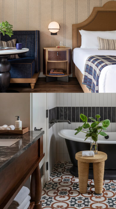 A bed with leather headboard, leather embossed side table, and blue sofa in a sunlit hotel room