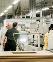 The Living Company production team inspecting a furniture production line
